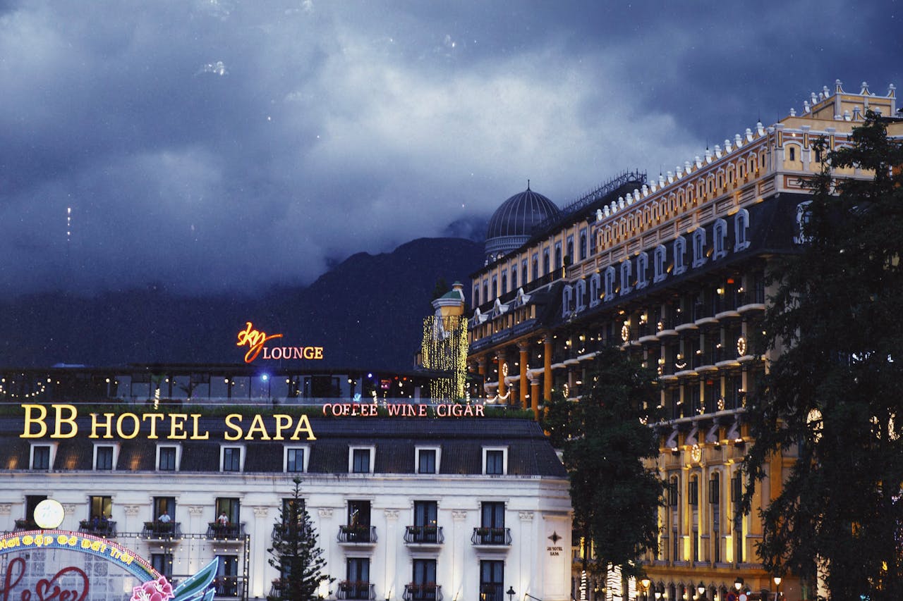 gallery-06 Scenic nighttime view of BB Hotel Sapa with atmospheric lighting and urban architecture.